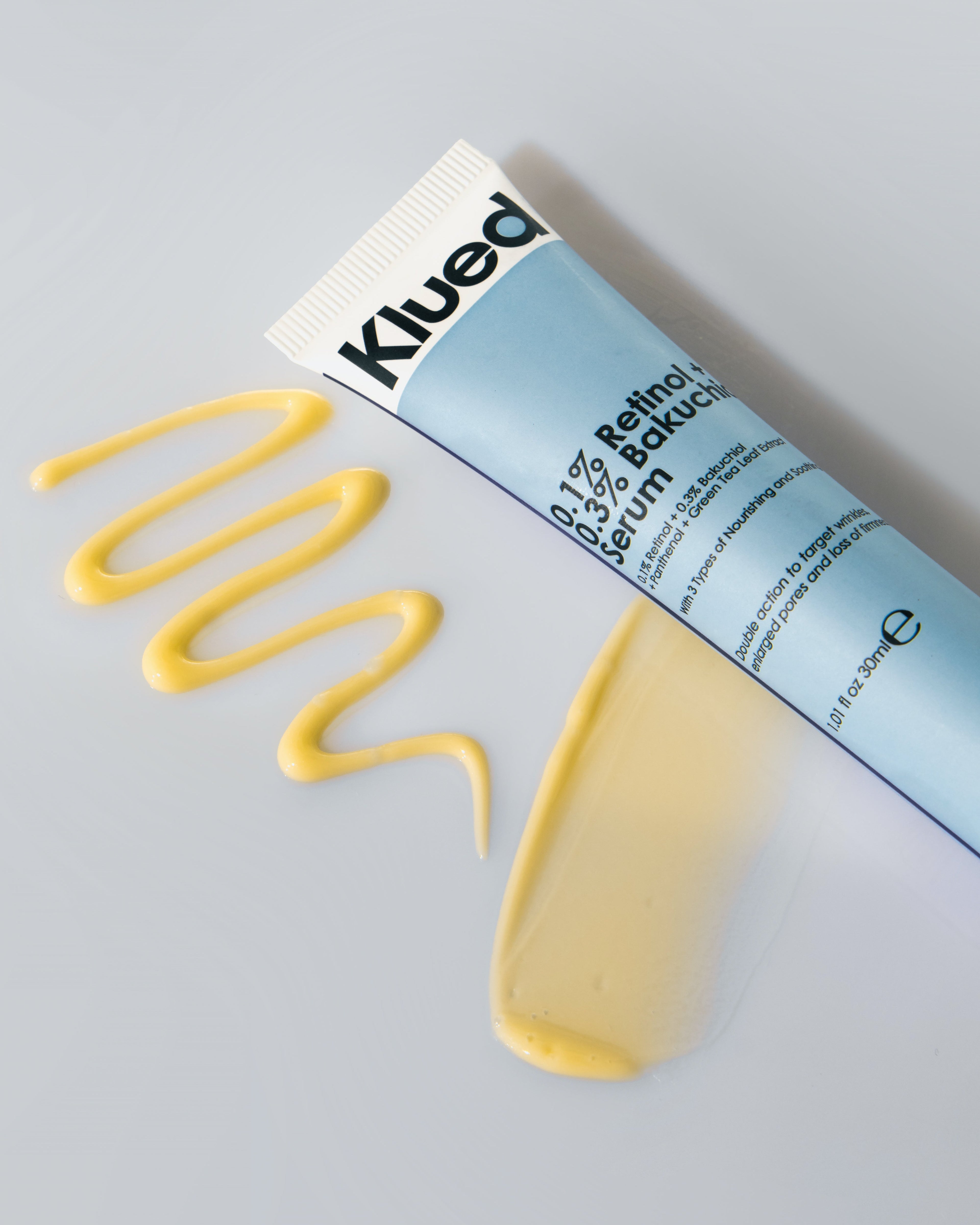 Klued 0.1% Retinol Serum in white background with Cream beside