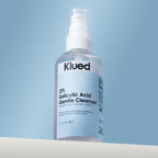 Klued 2% Salicylic Acid Gentle Cleanser bottle on a light blue background