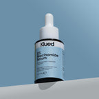 Klued 5% Niacinamide Serum bottle on a blue and gray gradient background