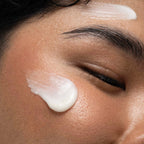 Close-up of a person applying cream to their face