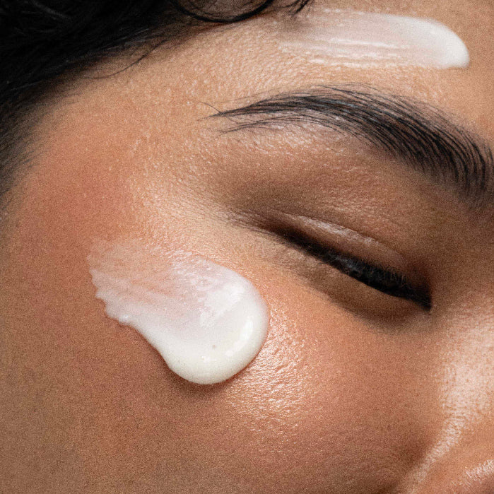 Close-up of a person applying cream to their face