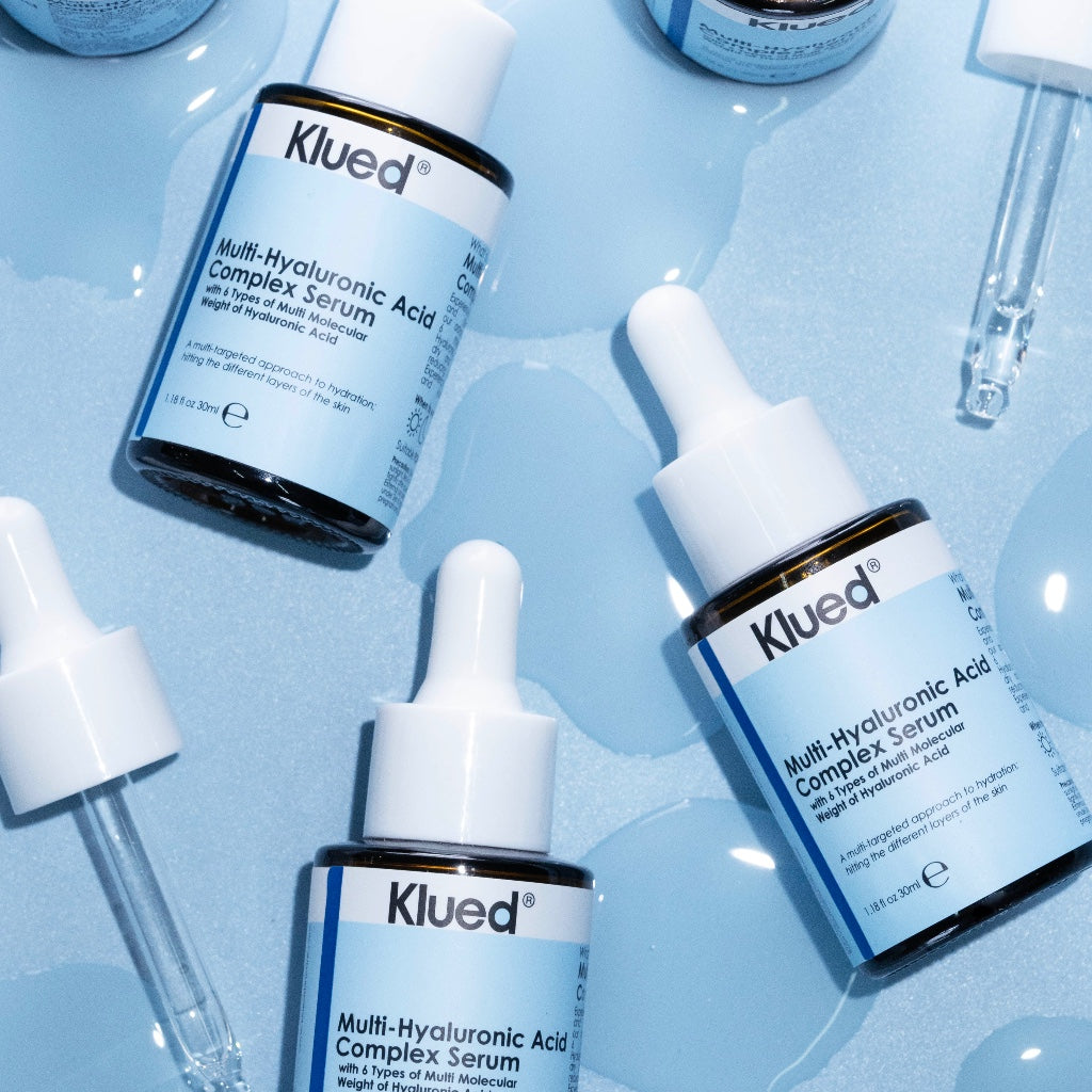 Klued Multi-Hyaluronic Acid Complex Serum bottles and droppers on a light blue background