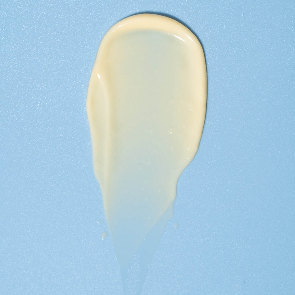 Beige cream sample on a blue background