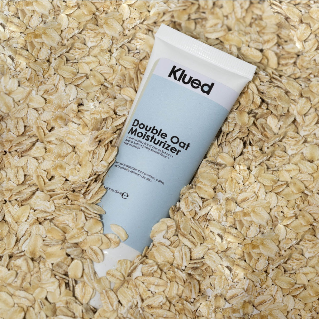 Klued Double Oat Moisturizer tube on a bed of oats