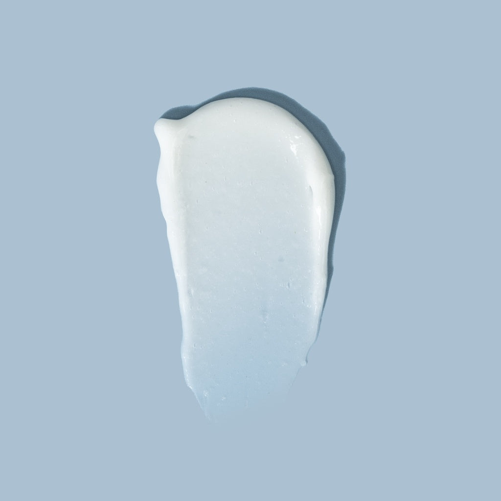 White cream swatch on a light blue background